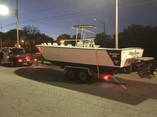 Sea Ray Thresher 1999 Sea Ray Thresher boat on trailer at dusk, parked on street.