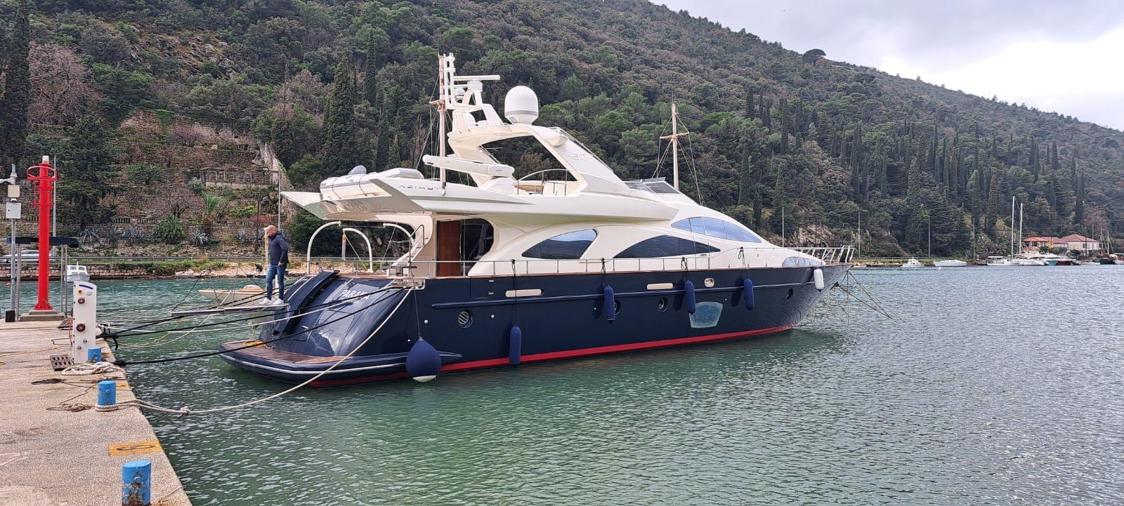 Azimut 80 Azimut 80 yacht from 2008 docked in a scenic marina with lush hillside backdrop.