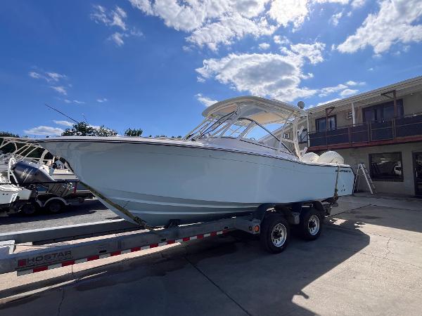 Grady-White Freedom 275 2025 Grady-White Freedom 275 boat on trailer under a sunny sky.