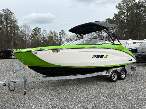 Yamaha Boats 255XD 2022 Yamaha Boats 255XD in green and white on a trailer, parked outdoors.