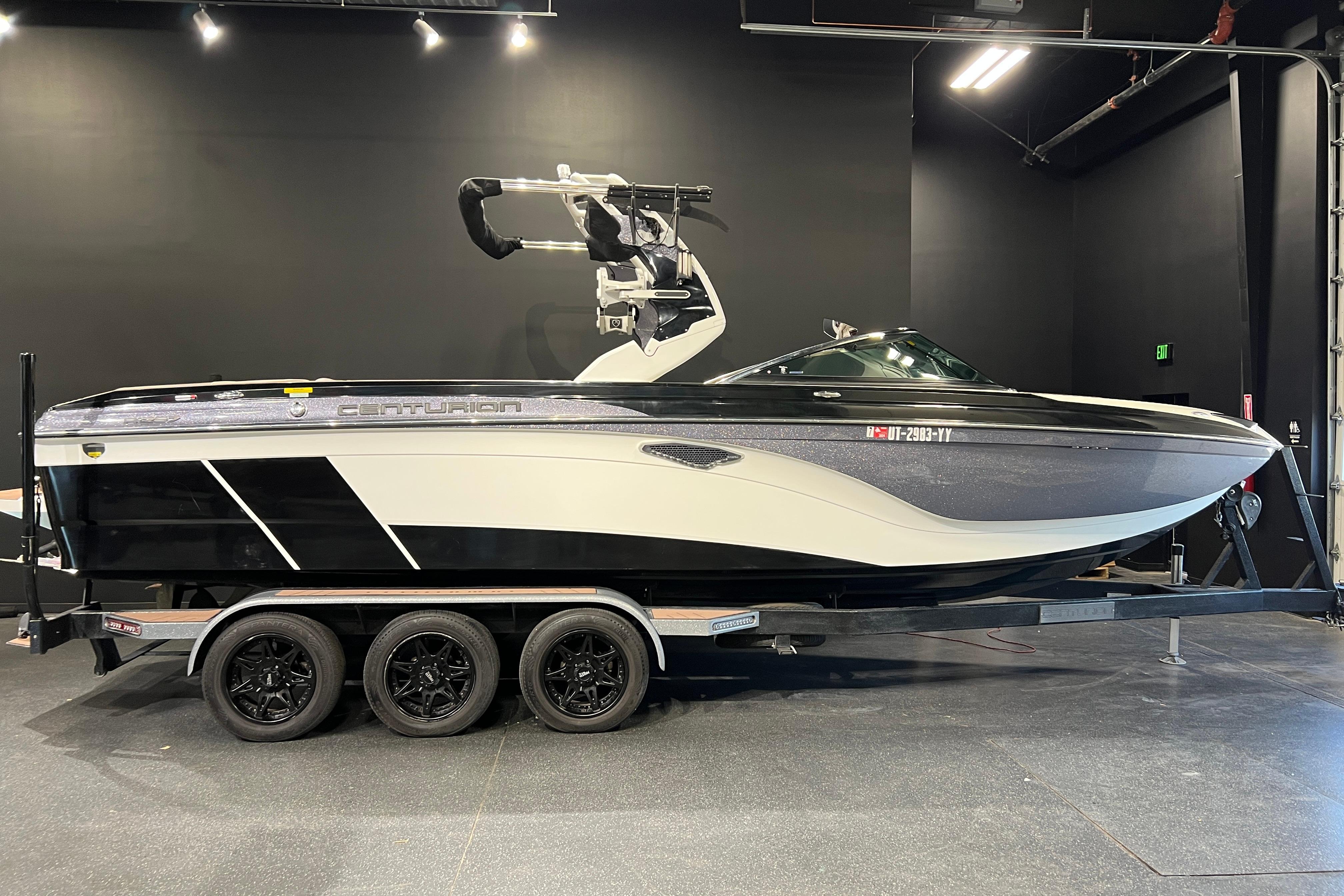 Centurion Ri257 2017 Centurion Ri257 boat on trailer in showroom, black and white design.