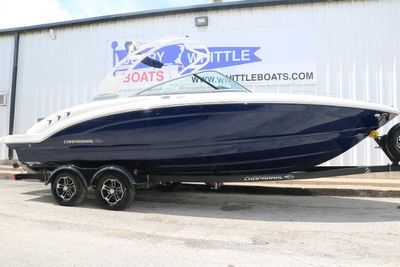 Chaparral 23 SSi 2024 Chaparral 23 SSi boat on trailer, parked outside a dealership.