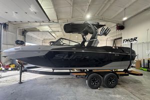 Supra SA 2026 Supra SA boat in a garage, sleek black design on a trailer.
