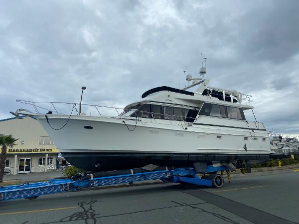 Ocean Alexander Custom Aft Deck Motor Yacht 1986 Ocean Alexander Custom Aft Deck Motor Yacht on trailer, cloudy sky background.