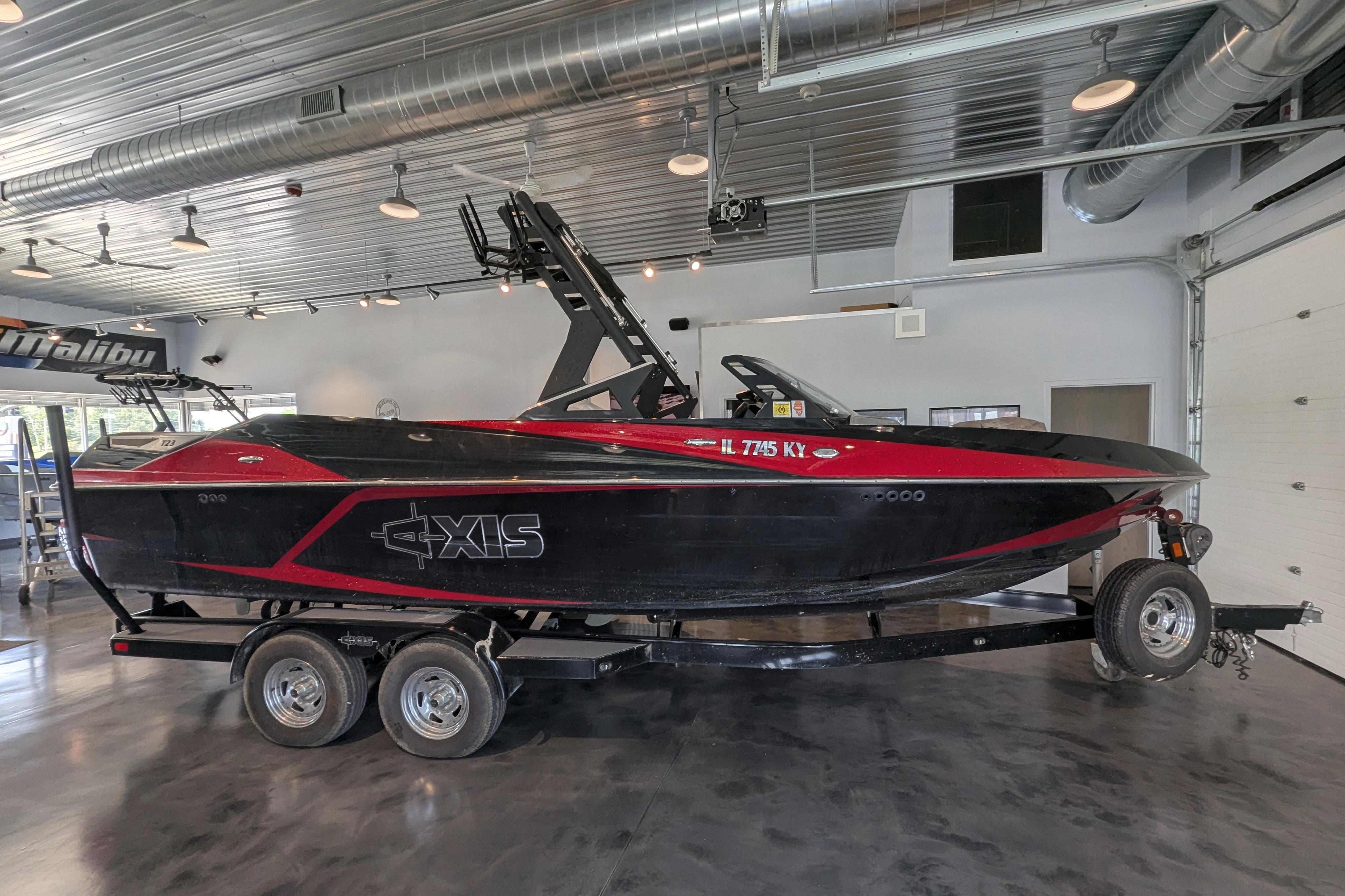 Axis T23 2018 Axis T23 boat in showroom, black and red design on trailer.
