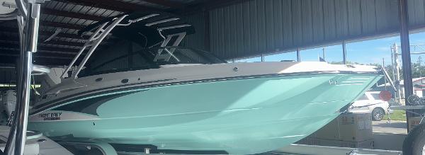 Monterey M-45 2025 Monterey M45 boat in a storage facility, featuring sleek design and mint green hull.
