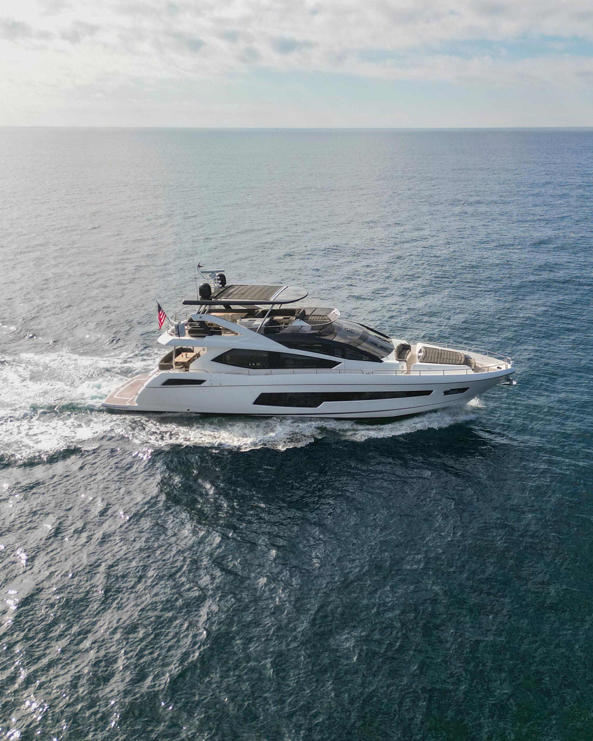 Sunseeker 75 Yacht Luxurious 2016 Sunseeker 75 Yacht cruising on open sea under clear skies.