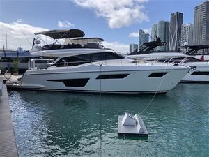Ferretti Yachts 500 2024 Ferretti Yachts 500 docked in a marina with city skyline backdrop.