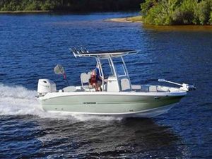 Stingray 216CC 2025 Stingray 216CC boat cruising on a scenic lake.