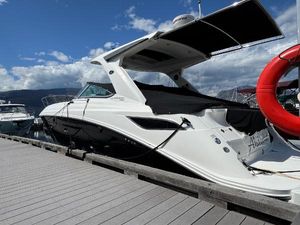 Sea Ray 350 Sundancer 2016 Sea Ray 350 Sundancer docked, featuring sleek design and covered seating area.