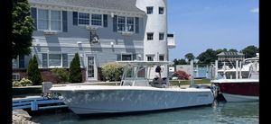 Sailfish 290cc 2022 Sailfish 290cc boat docked near a waterfront house.