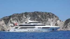 Benetti . Luxury Benetti yacht cruising near rocky coastline, 2015 model.