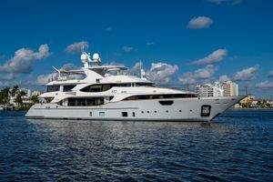 Benetti 140 Luxury Benetti 140 yacht from 2015 on a sunny day, cruising near a cityscape.