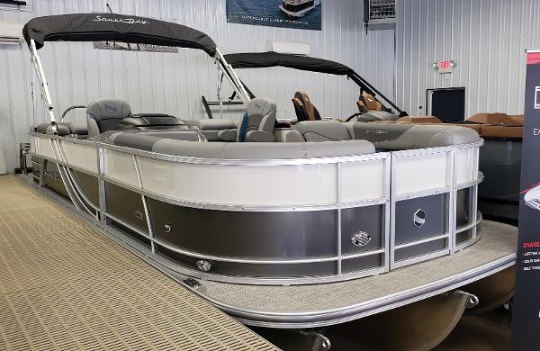 South Bay S224 RS 2023 South Bay S224 RS pontoon boat in showroom, featuring sleek design and comfortable seating.