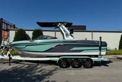 Centurion Ri245 2021 Centurion Ri245 boat on trailer, parked outdoors under clear blue sky.