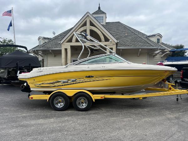 Sea Ray 200 Select 2004 Sea Ray 200 Select boat on trailer, parked near a building.