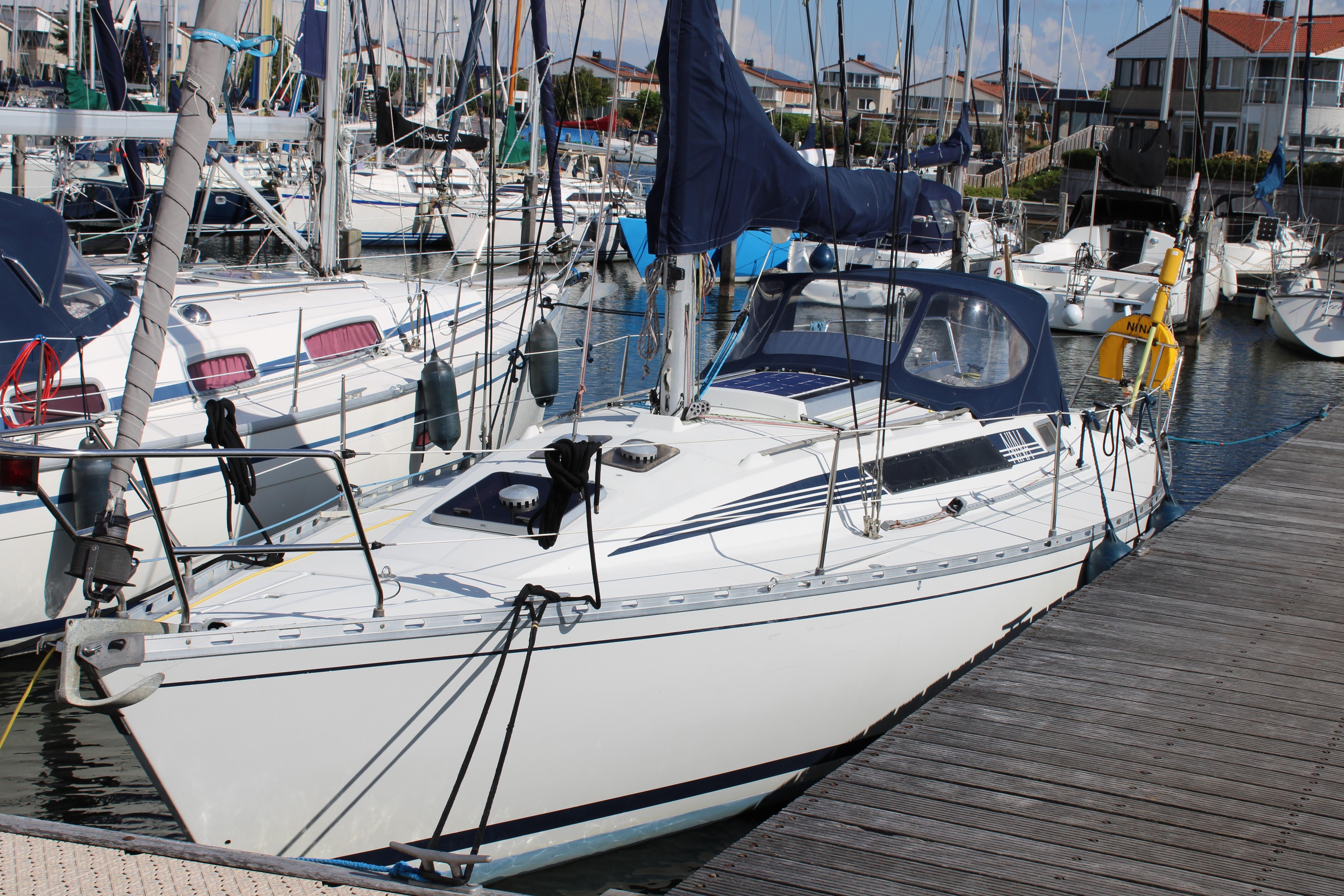 Beneteau First 345 1984 Beneteau First 345 sailboat docked in a marina, surrounded by other boats.
