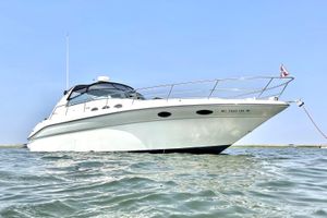 Sea Ray 370 Sundancer 1995 Sea Ray 370 Sundancer yacht anchored on calm water under clear blue sky.
