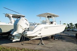 Edgewater 340CC 2024 Edgewater 340CC boat on display, featuring sleek design and powerful outboard engines.