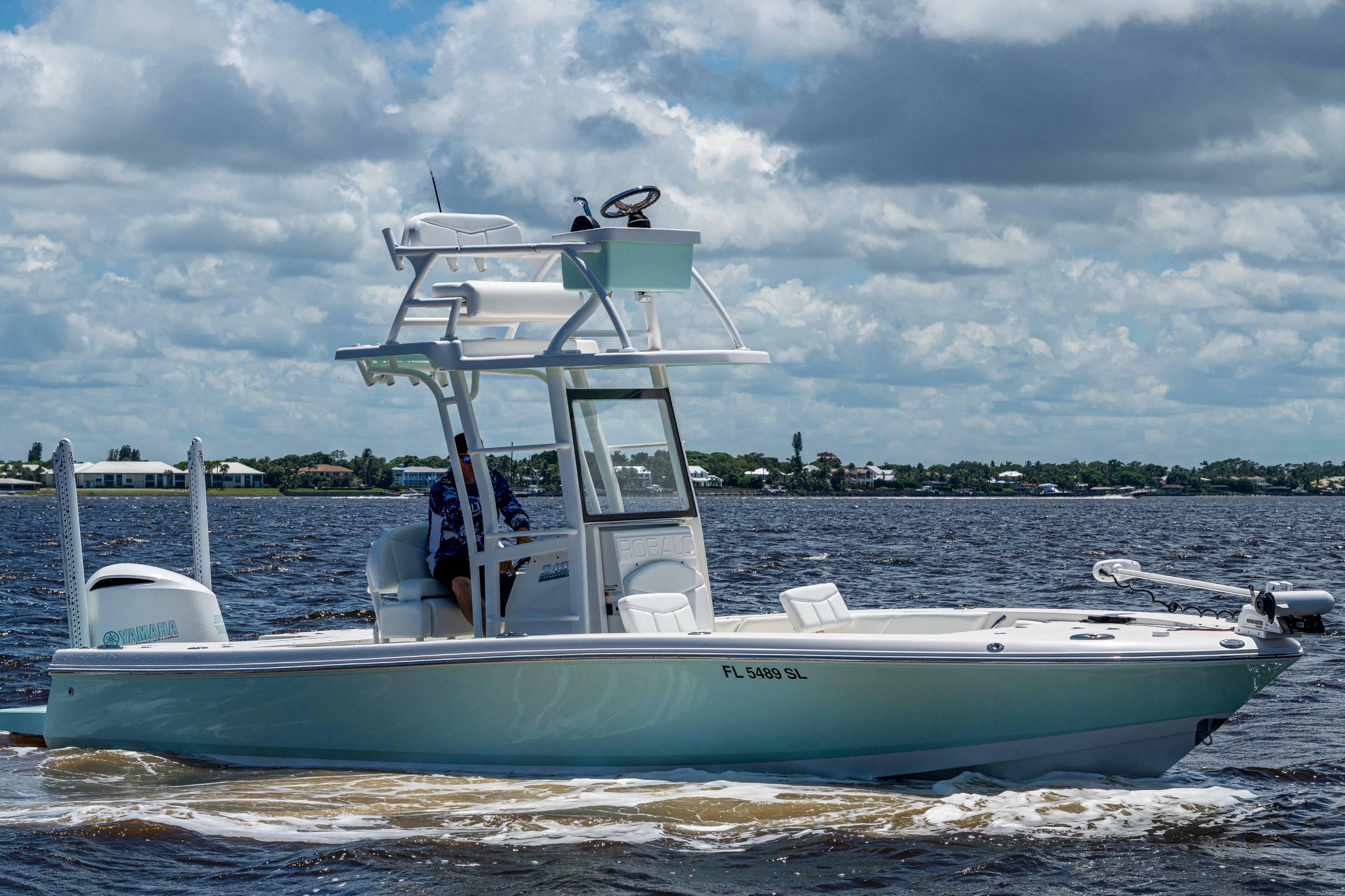Robalo 246 Cayman SD 2019 Robalo 246 Cayman SD boat cruising on a sunny day with cloudy skies.