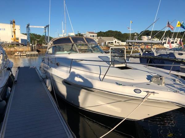 Sea Ray 330 Sundancer 1996 Sea Ray 330 Sundancer docked at marina under clear blue sky.