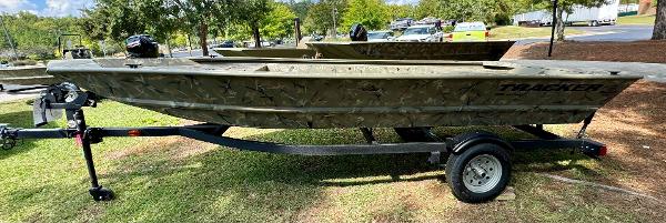 Tracker Grizzly 1648 Jon 2025 Tracker Grizzly 1648 Jon boat on trailer, parked on grass.