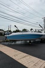 Stingray 211 DC 2025 Stingray 211 DC boat displayed on stands in a parking lot.