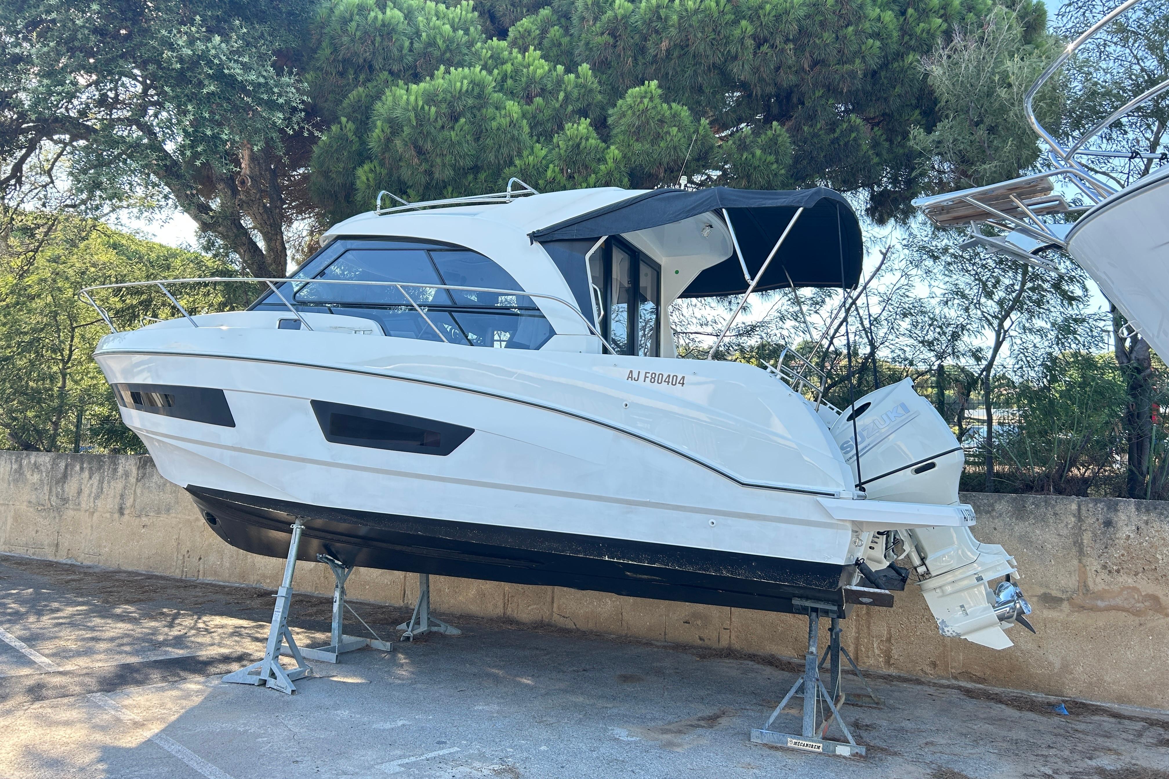 Beneteau Antares 9 OB 2018 Beneteau Antares 9 OB boat on stands, surrounded by trees.