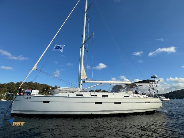 Bavaria 50 Sailing yacht Bavaria 50, 2013 model, anchored on calm water under a clear blue sky.