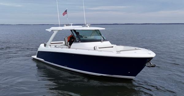 Tiara Yachts 38 LS 2023 Tiara Yachts 38 LS boat on calm water with American flag.