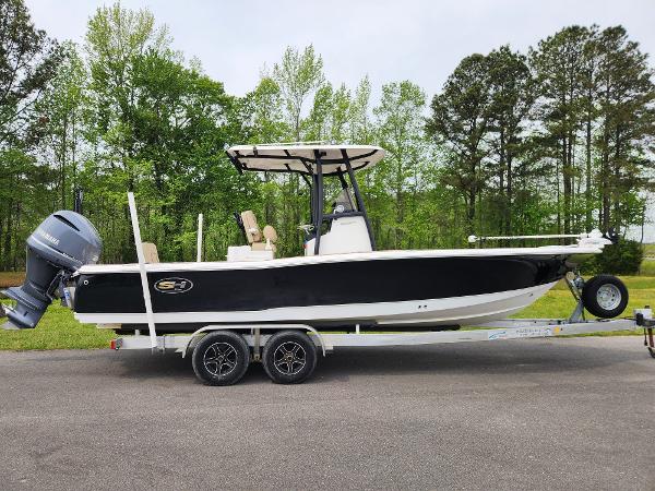 Sea Hunt BX 25 BR 2017 Sea Hunt BX 25 BR boat on trailer, black hull, outboard motor, parked outdoors.
