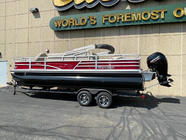Ranger Reata 220F 2024 Ranger Reata 220F pontoon boat on trailer, parked outside a building.