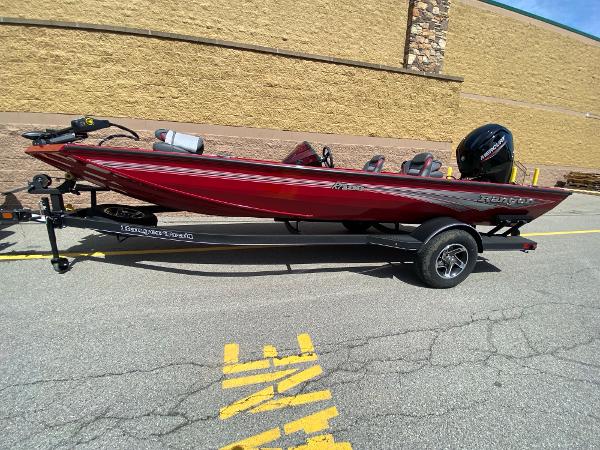 Ranger RT188 2024 Ranger RT188 boat in red on a trailer, parked outdoors.