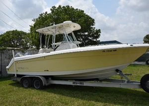 Robalo R260 Center Console 2006 Robalo R260 Center Console boat on a trailer in a grassy area.