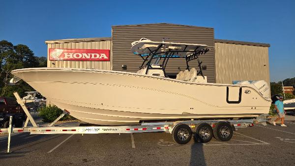 Sea Fox 328 Commander 2022 Sea Fox 328 Commander boat on a trailer outside a Honda dealership.