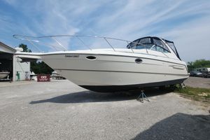 Maxum 3300 SCR 2000 Maxum 3300 SCR boat on dry dock, white hull, outdoor setting.