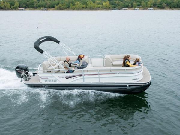 Ranger 220C 2023 Ranger 220C pontoon boat cruising on a lake with passengers.