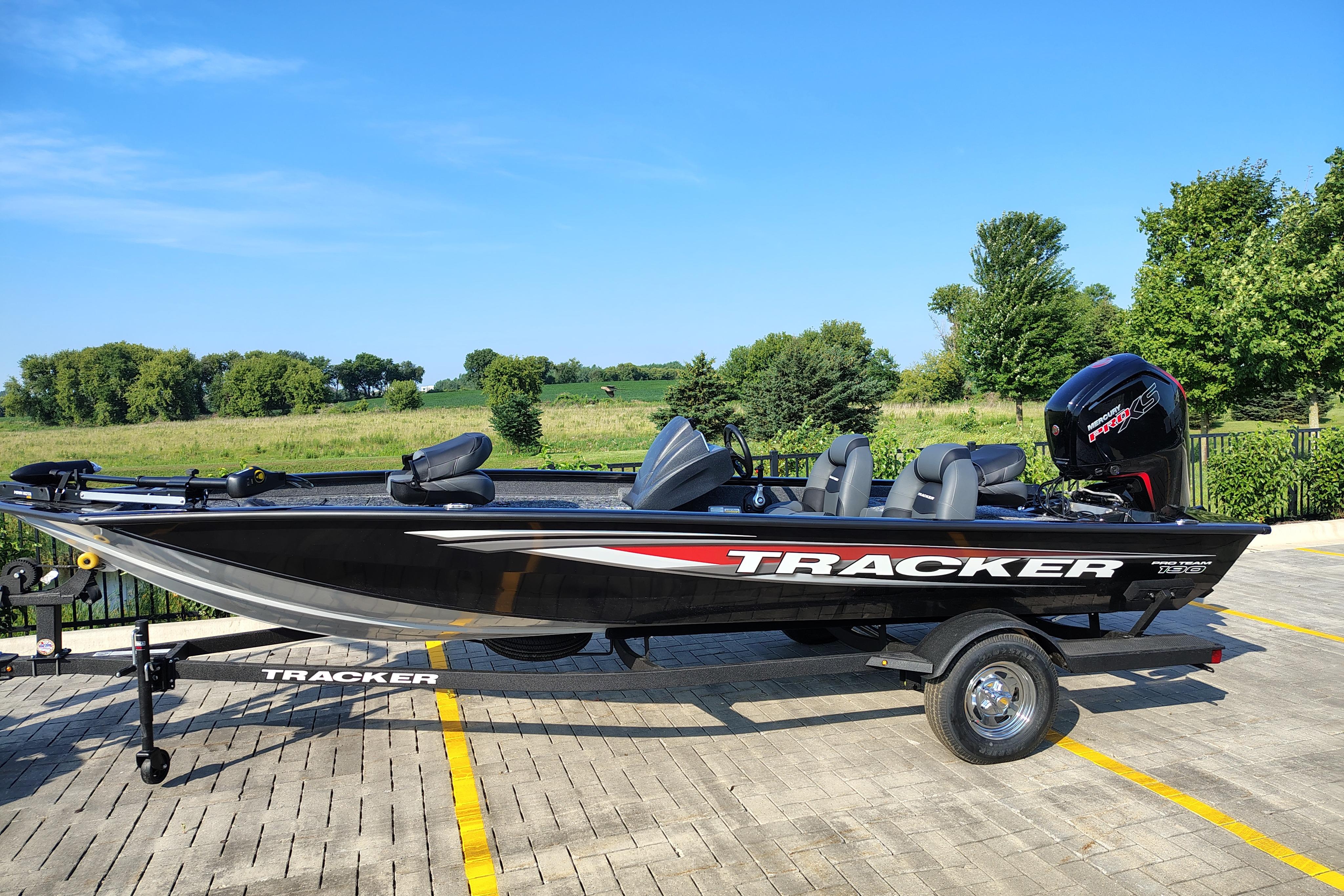 Tracker Pro Team 190 2026 Tracker Pro Team 190 boat on trailer, parked outdoors with scenic background.