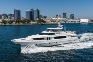 Westport 112 Luxurious 2012 Westport 112 yacht cruising near a city skyline.