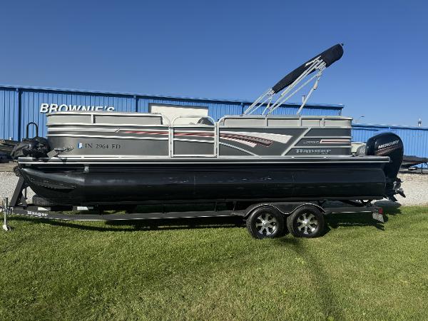 Ranger Reata 223C 2019 Ranger Reata 223C pontoon boat on trailer, parked on grass.