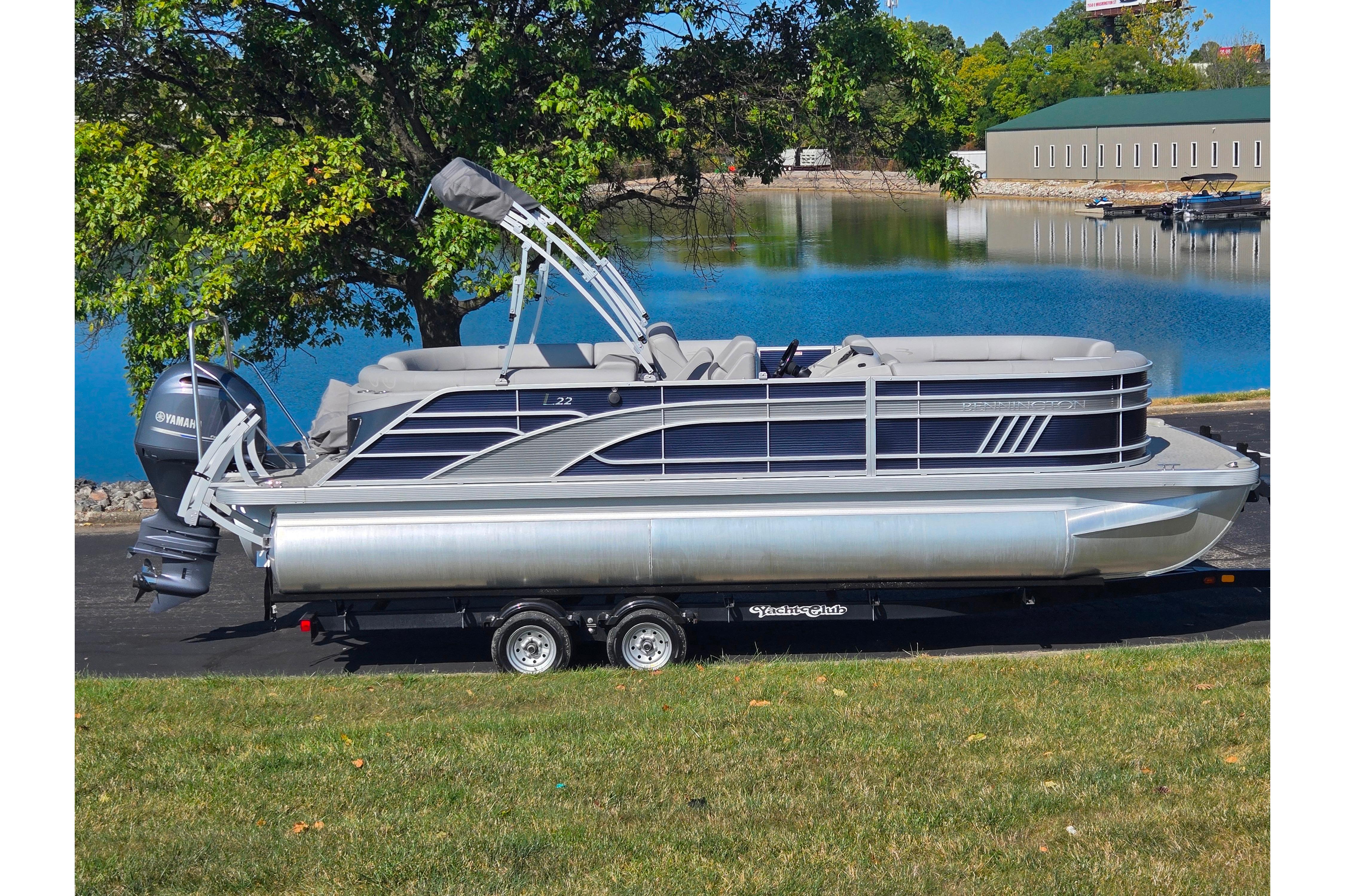 Bennington L 22 L-Bench 2022 Bennington L 22 L-Bench pontoon boat on trailer by a lake.