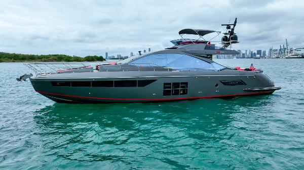 Azimut S7 Motor Yacht Azimut 2019 motor yacht on calm water with city skyline in background.