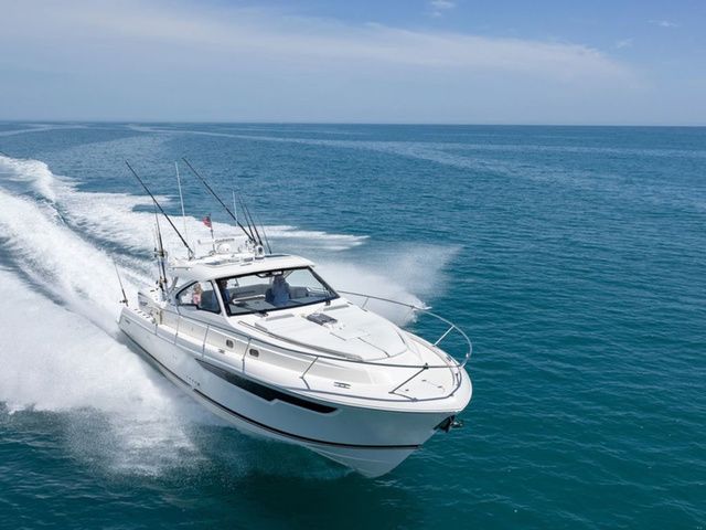Pursuit Boats OS 405 Offshore 2026 Pursuit Boats OS 405 Offshore cruising on open sea under clear blue sky.