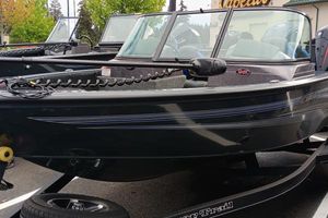 Ranger VS1682SC Angler 2024 Ranger VS1682SC Angler boat on trailer, sleek design, parked outdoors.