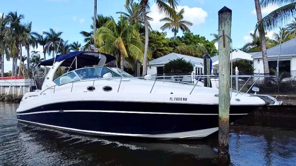 Sea Ray 340 Sundancer 2008 Sea Ray 420 Sundancer yacht docked near palm trees and waterfront homes.