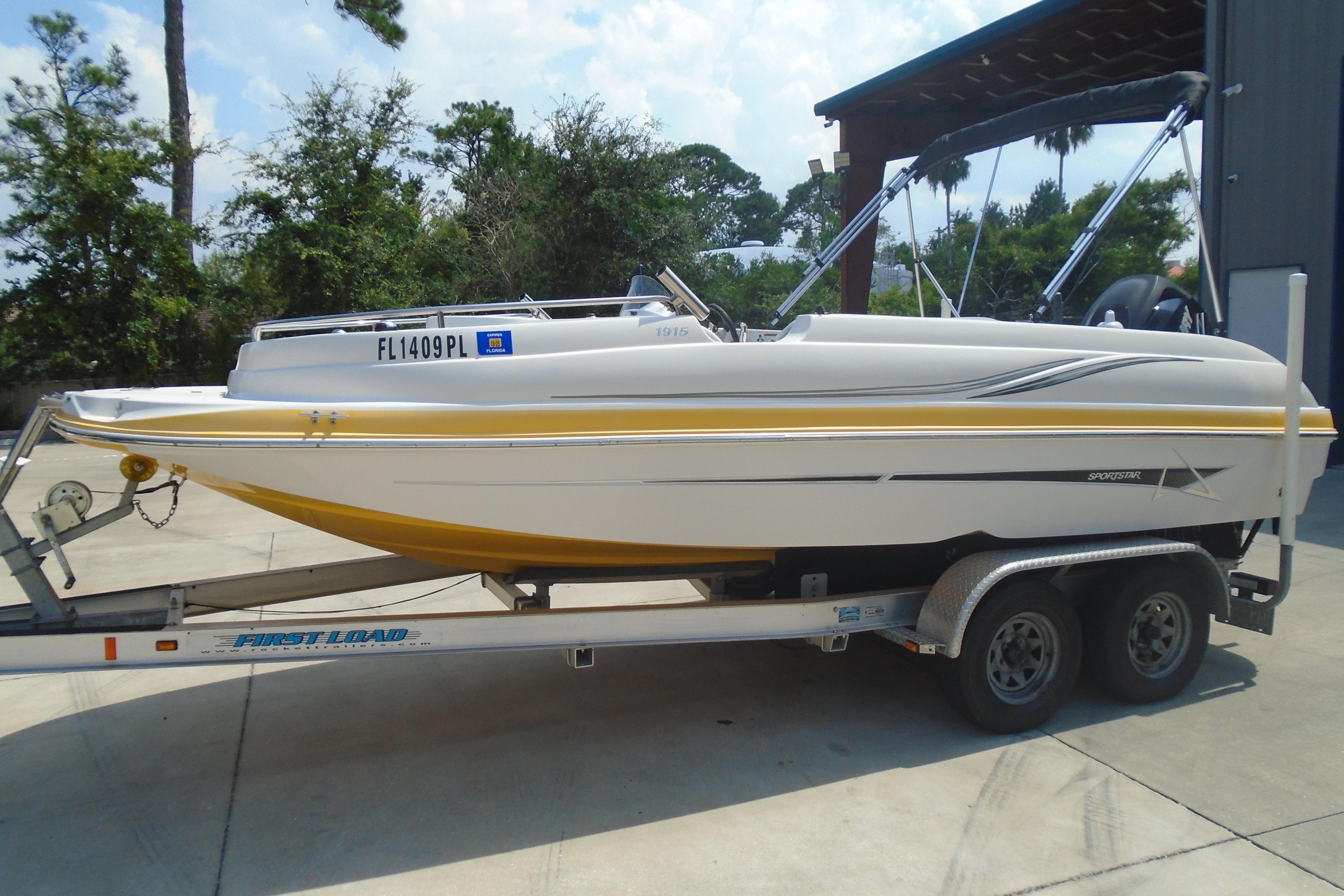 Starcraft Limited 1915 OB 2013 Starcraft Limited 1915 OB boat on trailer, parked outdoors.