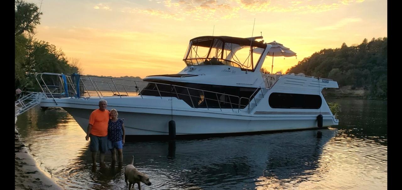 Bluewater Coastal 53 1992 Bluewater Coastal 53 yacht docked at sunset with people and dog nearby.