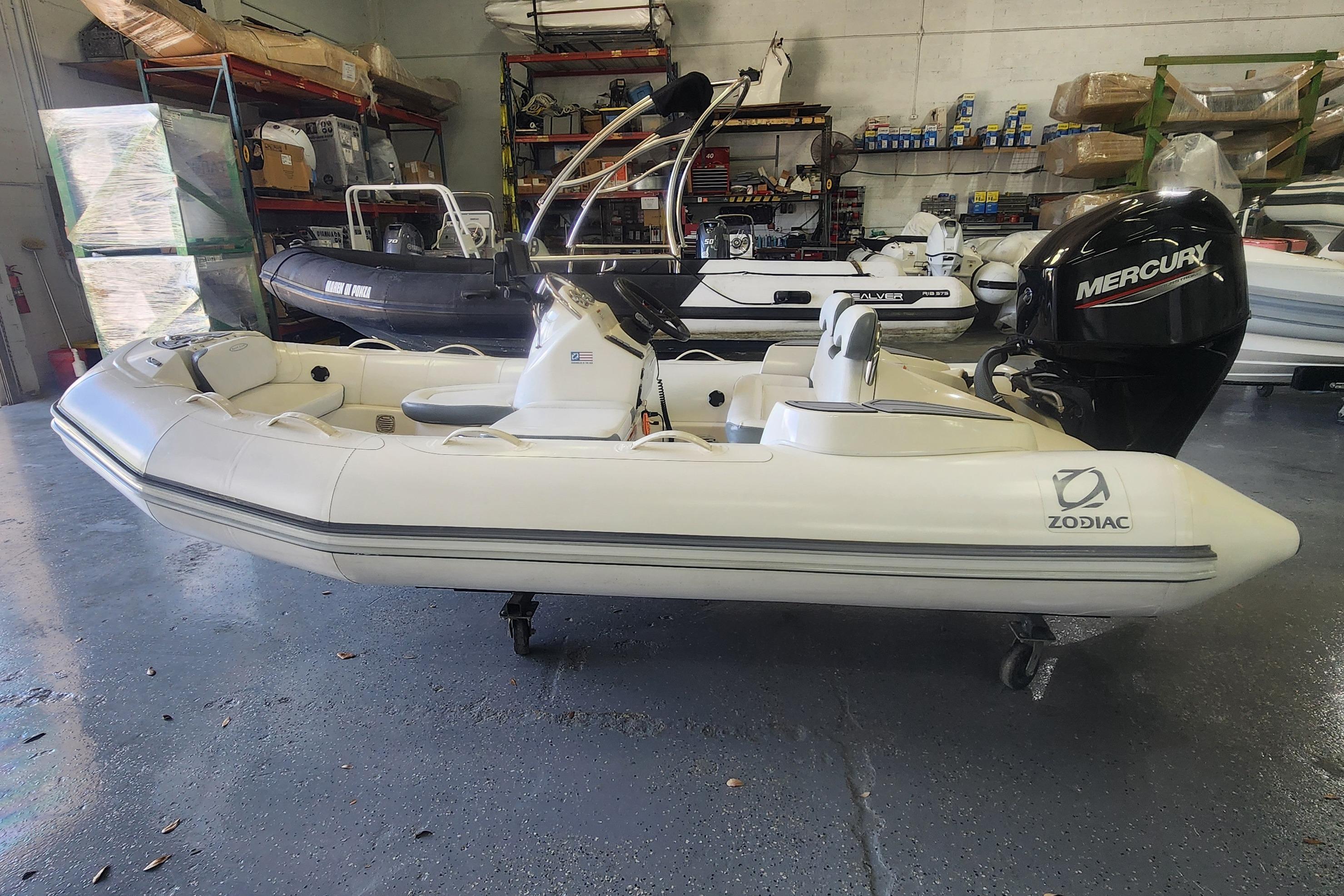 Zodiac Yachtline 400 2022 Zodiac Yachtline 400 inflatable boat with Mercury outboard motor in a showroom.