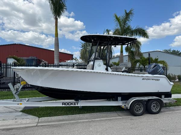 Sportsman Open 212 Center Console 2023 Sportsman Open 212 Center Console boat on trailer, parked near palm trees.