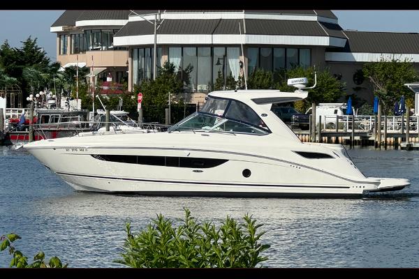 Sea Ray 350 Sundancer 2019 Sea Ray 350 Sundancer yacht docked near waterfront buildings.